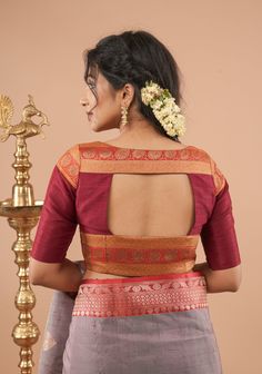 This maroon pure raw silk blouse exudes sophistication with its rich, deep hue and luxurious texture. Adorned with antique-tone zari panels, it offers a touch of vintage charm and intricate detailing. The blend of classic elegance and traditional craftsmanship makes this blouse a versatile addition to any wardrobe, ideal for both festive occasions and special events. The raw silk fabric ensures a comfortable fit while adding a refined touch to your ensemble. SIZE GUIDE : To determine your blouse Maroon Blouse Designs, Blouse Neck Patterns, Pattern Blouses, Raw Silk Blouse, House Of Blouse, Model Blouse, Blouses Designs, Raw Silk Fabric