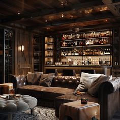 a living room filled with lots of furniture and bottles on the shelves above it's bar