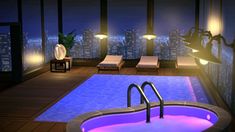 an indoor swimming pool with lounge chairs and city lights in the background at night time