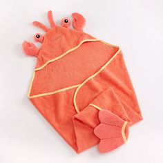 an orange towel with two pink crabs on it and one red crab under the cover