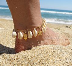 This beautiful beach dainty anklet or bracelet is made with cowrie shells, 24k gold plated brass pendants (seahourse, fish, starfish), 24k gold plated chain and 18k gold plated lobster clasp. An 1.5-inch extension chain is added to each bracelet. Your anklet or bracelet comes gift wrapped and shipped via priority registered air mail with tracking info available. Feel free to ask me any questions! Thanks for visiting and happy shopping :) Ocean-inspired Strand Anklets As A Gift, Shell Strand Anklets As Gift, Gold Strand Bracelet With Ocean-inspired Style, Bohemian Starfish Anklets As A Gift, Gold Shell Necklace With Starfish Charm On Strand, Adjustable Gold Strand Anklets, Gold Beachy Bracelet For Gifts, Beachy Gold Bracelets For Gifts, Beachy Gold Bracelets For Vacation