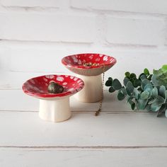 two red and white dishes sitting next to each other