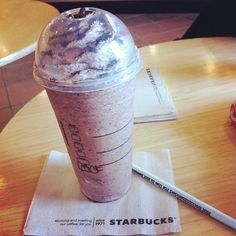 a starbucks drink sitting on top of a wooden table