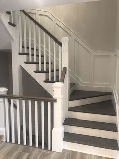 the stairs in this house are painted gray and white