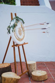 a wooden easel with an object on top of it and some logs around it