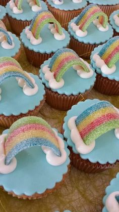 cupcakes with icing and rainbow decorations on them