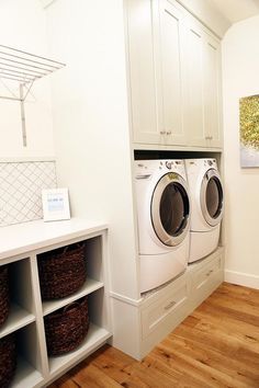 a washer and dryer in a white laundry room