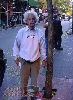 an old man standing next to a tree