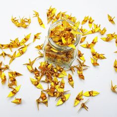 a glass jar filled with yellow origami pieces