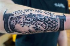 a man's arm with a tattoo on it that says trust no one,