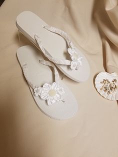 "Very simple Flat wedding sandals flipflop style 1/2\" heel. OFF-WHITE, ALSO CALLED DIAMOND WHITE. handmade flowers, the centers are a little darker than flowers; flowers are not white, flowers are Off-white. Very dressy and simple please look at the pictures. Sizes: Small: 5.5 - 6.5 Medium: 7-8 Large: 8.5 - 9.5, X-Large: 10 - 11 Please contact for any questions ON SIZING, or ANY other concerns. FINAL SALE, NO RETURNS, NO EXCHANGES, NO EXCEPTIONS." White Closed Toe Flip Flops For Vacation, White Closed Toe Flip Flops For Beach, White Sandals For Beach Wedding In Spring, Elegant White Toe Post Flip Flops, Elegant Flower-shaped Beach Sandals, Elegant White Wedding Shoes For Beach Ceremony, Adjustable White Sandals For Beach Wedding, White Summer Flip Flops For Party, White Round Toe Beach Wedding Shoes