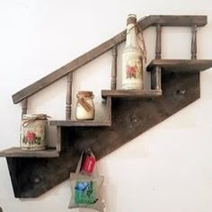 an old wooden shelf with some jars on it and a bag hanging from the bottom