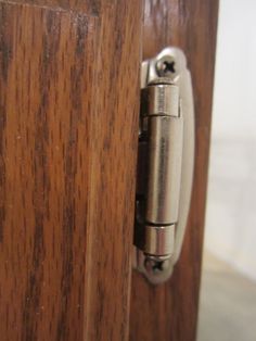 a close up of a door handle on a wooden door