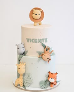 a three tiered cake decorated with animals and the words vignette on it