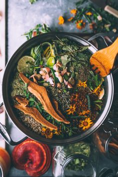 a bowl filled with broccoli, mushrooms and other foods on top of a table