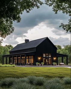 a large black barn style house with lots of windows