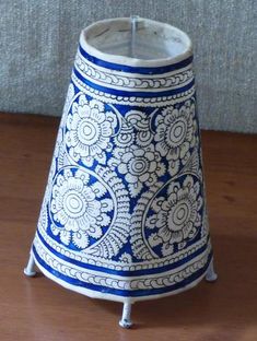 a blue and white vase sitting on top of a wooden table