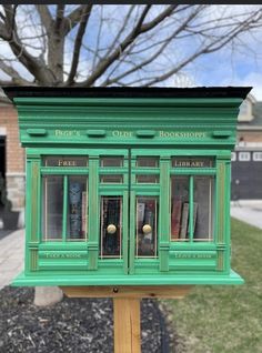 a green book store on a wooden stand