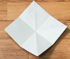 an origami piece sitting on top of a wooden floor