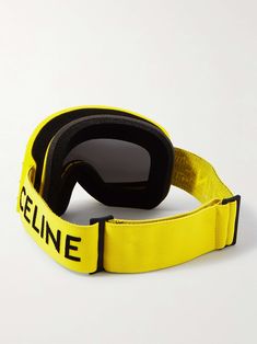 a pair of ski goggles sitting on top of a yellow strap with the word zeline printed on it