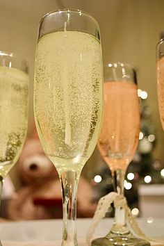 three champagne flutes sitting on top of a table