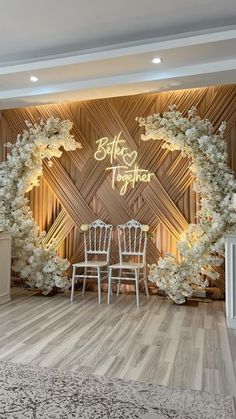 a room decorated with white flowers and chairs