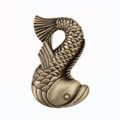 a bronze colored fish statue on a white background