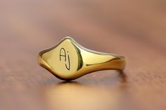 This delicate name initial ring is a beautifully crafted piece that combines elegance with a personal touch. The teardrop shaped design, perfect for showcasing a single initial, adds a unique twist to traditional jewelry styles. Made with high-quality materials, this personalized ring serves as a thoughtful gift for her, whether for birthdays, anniversaries, or just because. A meaningful gift that can be cherished every day, this custom ring is ideal for anyone who loves dainty, sophisticated je Modern Pear-shaped Rings As Gift, Teardrop Promise Ring With Polished Finish, Classic Gold Teardrop Rings, Classic Pear-shaped Ring For Gift, Classic Pear-shaped Ring Gift, Classic Teardrop Rings For Gift, Classic Teardrop Rings With Polished Finish, Classic Teardrop Ring With Polished Finish, Gold Teardrop Rings With Polished Finish