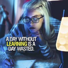 a woman with glasses is looking at her computer screen and writing on the paper that says,'a day without learning is a day wasted '