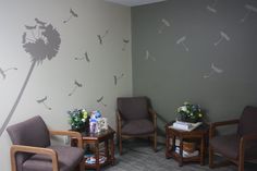 the waiting room is decorated with dandelion stencils on the wall and chairs