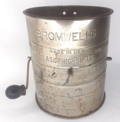 an old metal bucket with a black handle