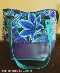 Purple, turquoise, and amaryllis floral color-blocked, large handbag/shoulder bag. Blue Hobo Tote Bag With Top Carry Handle, Blue Hobo Bag With Top Carry Handle, Blue Box Bag With Removable Pouch For Errands, Turquoise Top Handle Travel Bag, Turquoise Top Handle Shoulder Bag For Travel, Turquoise Bags With Leather Handles For Everyday Use, Turquoise Rectangular Bag With Detachable Strap, Rectangular Turquoise Bag With Detachable Strap, Turquoise Top Handle Shopping Bag