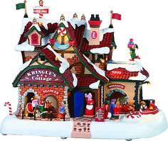 a christmas village with santa claus and other holiday decorations on top of the building,