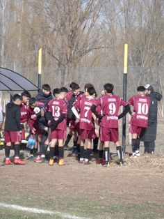 a group of young men standing next to each other on a field