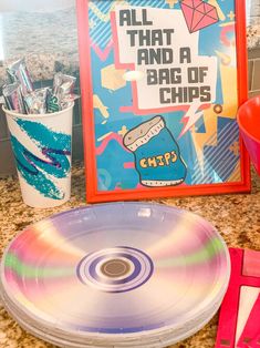 a cd sitting on top of a counter next to a cup and some other items