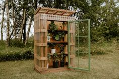 a wooden potting shed with plants in it