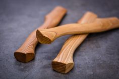 two wooden utensils laying on top of each other