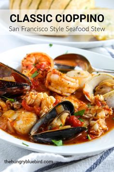 a white plate topped with seafood and clams