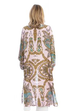 Our Regal Medallion Printed Midi Duster displays beautiful, large, multicolored paisleys and regal medallion prints mixed with botanical and floral elements. The duster is a midi length that accentuates the wearer's leg and creates a pleasing drape with its lightweight and breathable fabric. The duster can be securely closed with the fabric belt making it a great cover-up to wear at the beach or a resort. Materials: 100% Rayon Bohemian Long Kimono With Paisley Print, Long Paisley Print Kimono For Festivals, Spring Kimono With Paisley Print And Kimono Sleeves, Long Bohemian Kimono With Paisley Print, Long Kimono With Paisley Print For Festivals, Elegant Multicolor Kimono For Beach, Elegant Multicolor Kimono For Vacation, Elegant Multicolor Beach Kimono, Elegant Multicolor Printed Kimono