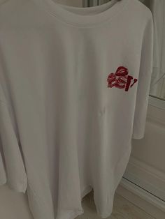 a white shirt with red writing on it