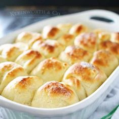 a casserole dish filled with bread on top of a green and white towel