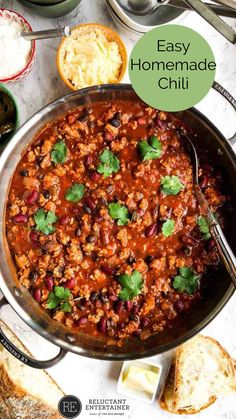 an easy homemade chili recipe in a skillet with bread and butter on the side