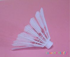 several white plastic tooth brushes on a pink background