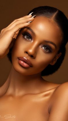 a close up of a woman with makeup on her face and hands behind her head