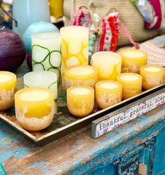 many candles are sitting on a tray