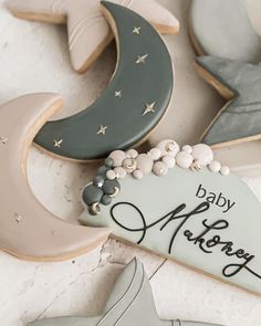 decorated cookies with the words baby shower and moon on them are laying next to each other