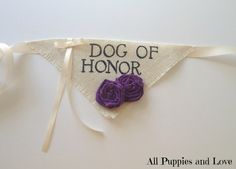 a purple flower is on top of a white banner that says dog of honor