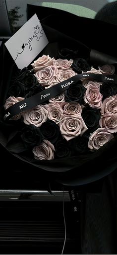 a bunch of flowers that are sitting on a car seat belt with a note attached to it