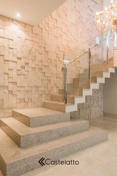 there is a staircase in the middle of this room with stone walls and flooring