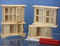 two wooden shelves sitting next to each other on top of a glass table with a red object in front of them